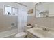 Well-lit bathroom featuring a tub, shower, vanity, and nautical themed decor at 6900 Avrum Dr, Denver, CO 80221