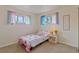 Cozy bedroom with cheerful decor, two windows, and a comfortable layout at 6900 Avrum Dr, Denver, CO 80221