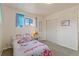 Bright bedroom showcasing cozy decor and ample natural light from the window at 6900 Avrum Dr, Denver, CO 80221