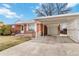 Exterior of brick home with a covered carport and extra storage at 6900 Avrum Dr, Denver, CO 80221
