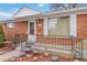 Inviting front entrance with wrought iron railings and a well-lit porch at 6900 Avrum Dr, Denver, CO 80221