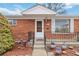 Inviting front entrance with wrought iron railings and a well-lit porch at 6900 Avrum Dr, Denver, CO 80221
