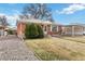 Charming brick home with manicured bushes and rock landscaping at 6900 Avrum Dr, Denver, CO 80221