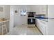 Cozy kitchen featuring white cabinets and an eat-in area with natural light at 6900 Avrum Dr, Denver, CO 80221