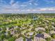 Scenic aerial view showcasing this home near a golf course, lake, and community amenities at 11585 Decatur St # B, Denver, CO 80234