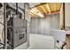 Unfinished basement area with concrete wall, utility sink, and exposed beams at 11585 Decatur St # B, Denver, CO 80234