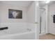 Bright bathroom featuring soaking tub and glass enclosed shower at 11585 Decatur St # B, Denver, CO 80234