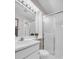 Bright bathroom features vanity with framed mirror and glass enclosed shower at 11585 Decatur St # B, Denver, CO 80234