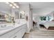 Well-lit bathroom with double sinks, neutral paint and attached bedroom at 11585 Decatur St # B, Denver, CO 80234