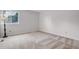 Carpeted bedroom featuring neutral paint, floor lamp, and large window at 11585 Decatur St # B, Denver, CO 80234