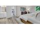 Bright bedroom featuring a large bed and an open layout to the bathroom at 11585 Decatur St # B, Denver, CO 80234