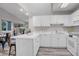 Bright kitchen with white cabinets, stainless steel appliances, and open layout at 11585 Decatur St # B, Denver, CO 80234