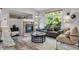 Cozy living room with stone fireplace, large windows and comfortable seating area at 11585 Decatur St # B, Denver, CO 80234