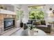 Living room with stone fireplace, large windows, and comfortable seating at 11585 Decatur St # B, Denver, CO 80234