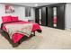 Bedroom with large closets, neutral carpet, and a bright window at 6511 Shea Pl, Highlands Ranch, CO 80130