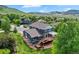 Aerial view of the home, deck, patio, and landscaping against a mountain backdrop at 18967 W 54Th Ln, Golden, CO 80403