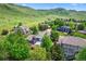 Aerial view of a residential neighborhood nestled among rolling hills and mature trees at 18967 W 54Th Ln, Golden, CO 80403