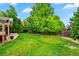 Green backyard with a privacy fence and patio, creating a serene outdoor space at 18967 W 54Th Ln, Golden, CO 80403