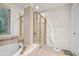 Bathroom includes a soaking tub, walk-in shower with glass door, and a window at 18967 W 54Th Ln, Golden, CO 80403