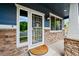 Close-up of an inviting front entrance with decorative door, brick accents, and stylish lighting at 18967 W 54Th Ln, Golden, CO 80403