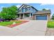 Inviting two-story home with a covered porch, blue siding, and a well-maintained front yard at 18967 W 54Th Ln, Golden, CO 80403