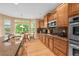 Well-equipped kitchen with wood cabinets, granite countertops, stainless steel appliances, and a sunny breakfast nook at 18967 W 54Th Ln, Golden, CO 80403