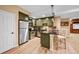 Charming kitchen with stainless appliances, tiled backsplash, and breakfast bar with seating at 18967 W 54Th Ln, Golden, CO 80403