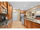 Gourmet kitchen with stainless steel appliances, wood cabinets, granite counters, and an island with a sink at 18967 W 54Th Ln, Golden, CO 80403