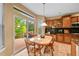 Bright eat-in kitchen featuring wood floors, stainless appliances, granite countertops and deck access at 18967 W 54Th Ln, Golden, CO 80403