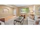 Cozy living room featuring a plush sofa, accent chair, and a front door view through the window at 18967 W 54Th Ln, Golden, CO 80403