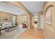 Open-concept living room with neutral tones, hardwood floors, and carpet, with a view of the dining area at 18967 W 54Th Ln, Golden, CO 80403