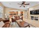 Warm living room with hardwood floors, a leather sofa, and an open view into the kitchen at 18967 W 54Th Ln, Golden, CO 80403