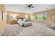 Spacious main bedroom features a ceiling fan and a large window overlooking the lush landscape at 18967 W 54Th Ln, Golden, CO 80403