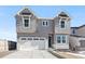 Two-story house with gray siding, white trim, and a two-car garage at 13264 Blue Amber Ct, Parker, CO 80134