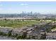 Panoramic aerial view of neighborhood showcasing the city skyline in the distance at 5445 Verbena St, Denver, CO 80238