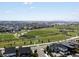 This high-angle shows a park area within a residential neighborhood with city views in the distance at 5445 Verbena St, Denver, CO 80238