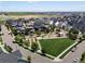 This aerial captures a park area and surrounding neighborhood with views of the city skyline at 5445 Verbena St, Denver, CO 80238