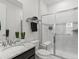 Stylish bathroom with marble shower, modern fixtures, and floating vanity at 5445 Verbena St, Denver, CO 80238