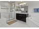 Beautiful bathroom with a soaking tub, tiled shower and dual sink vanity at 5445 Verbena St, Denver, CO 80238