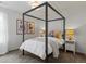Bedroom features a large bed frame with a white comforter and two bedside tables at 5445 Verbena St, Denver, CO 80238