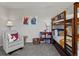 A bedroom with a bunkbed, comfy chair and lots of character at 5445 Verbena St, Denver, CO 80238