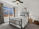 Cozy bedroom with large window providing natural light and comfortable furnishings at 5445 Verbena St, Denver, CO 80238