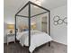Bedroom with canopy bed, carpet, and a view into a walk-in closet at 5445 Verbena St, Denver, CO 80238