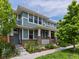 Inviting home exterior with a covered porch, brick accents, and lush greenery surrounding the walkway at 5445 Verbena St, Denver, CO 80238
