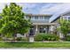 Charming two-story home with well-manicured landscaping, colorful flowerbeds, and mature trees at 5445 Verbena St, Denver, CO 80238