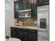 Close up of updated kitchen with granite countertops and stainless steel appliances at 5445 Verbena St, Denver, CO 80238
