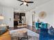 Open living room with modern furniture, a ceiling fan, and a view into the kitchen at 5445 Verbena St, Denver, CO 80238