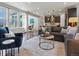 Open living room showcases a modern design with recessed lighting and views to the outside deck at 5445 Verbena St, Denver, CO 80238