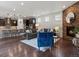 Open-concept living room flowing into the kitchen with a stone fireplace and comfortable seating at 5445 Verbena St, Denver, CO 80238