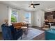 Inviting living room features hardwood floors, a stylish leather couch, a ceiling fan, and abundant natural light at 5445 Verbena St, Denver, CO 80238